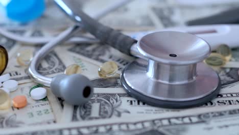 medical,-treatment-expenses,-concept,-pills-on-money,-dollars,-dolly-shot