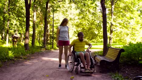 Young-disable-man-with-his-wife-on-a-walk-in-the-park