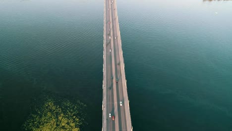 Aerial-top-view-of-bridge-road-automobile-traffic-of-many-cars,-transportation-concept