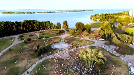 CHERKASY,-UKRAINE---AUGUST-24,-2018-:-aerial-video-with-drone,-the-celebration-of-Independence-Day,-many-people-walk-in-park-on-banks-of-the-Dnieper-River,-hot-summer-day