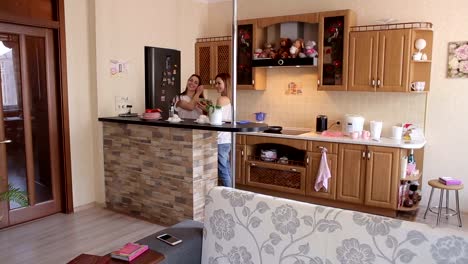 Two-young-beautiful-girls-prepare-a-vegetable-salad-in-the-kitchen.