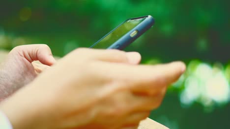 Woman-hand-using-smartphone-in--cafe-background.-Business,-financial,-trade-stock-maket-and-social-network-concept.