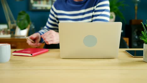 Casual-Businessman-Working-On-Laptop-At-Home-Office