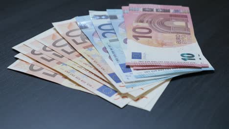 Euro-money-banknotes-taking-from-the-table-4K-2160p-30fps-UHD-footage---Different-European-Union-banknotes-grouped-by-hand-4K-3840X2160-UltraHD-video