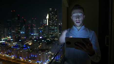 Caucasian-man-using-digital-tablet-for-internet-and-communications-with-cityscape-background