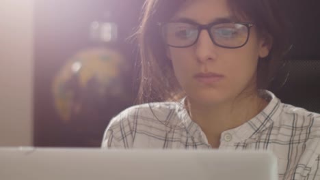 Close-up-footage-of-female-with-glasses-looking-at-computer