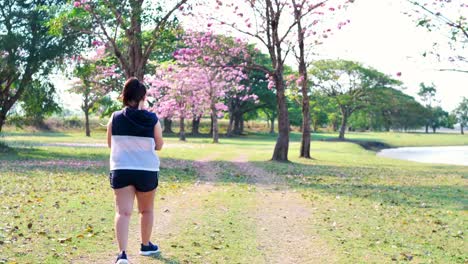 An-Asian-woman-walking-in-natural-sunlight-in-the-morning.
She-is-trying-to-lose-weight-with-exercise.--concept-health-with-exercise.