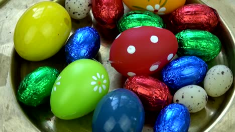 Rotating-colorful-Easter-eggs-in-brass-plate,-Easter-background