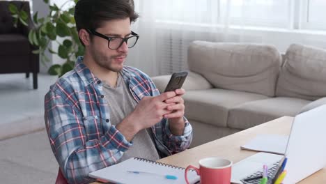 Young-man-text-messaging-on-mobile-phone