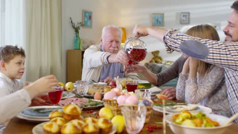 Mann-gießt-Getränke-für-Familie-zu-Ostern