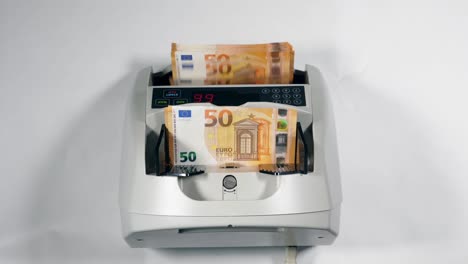 White-currency-counter-checks-euros-in-it.