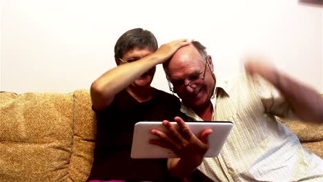 Attractive-adult-woman-and-adult-man-make-a-video-call-with-their-family-on-a-tablet-pc.