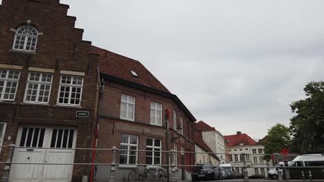 Bruges,-Belgium---May-2019:-View-of-the-water-channel-in-the-city-center.-Tourist-walk-on-the-water-canals-of-the-city.-View-from-a-tourist-boat.