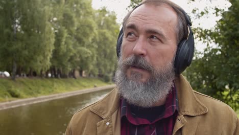 Aged-Man-Listening-to-Music-Outdoors