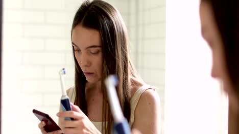 Woman-using-phone-in-bathroom