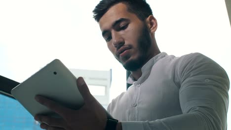 Man-working-on-tablet-PC