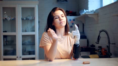 Girl-changes-batteries-of-a-bionic-hand,-close-up.