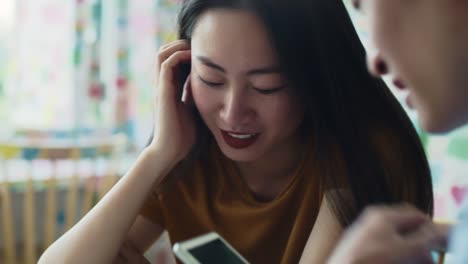 Handheld-view-of-couple-enjoying-the-free-internet-at-cafe