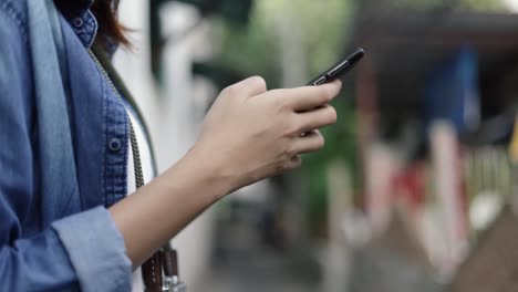 Close-up-hands-typing-message-on-smartphone-browsing-social-media-communication.