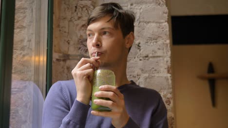 Dark-haired-guy-enjoys-drinking-delicious-vegetable-fresh