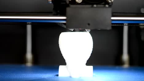 3D-printer-prints-the-form-of-white-plastic