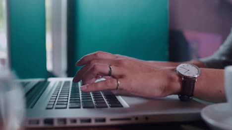 Close-up.-Female-hand-with-a-wristwatch-typing-on-a-laptop-keyboard