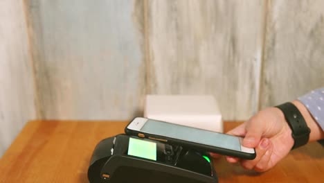 Close-up-view-process-of-contactless-payment.-Seller-put-the-payment-terminal