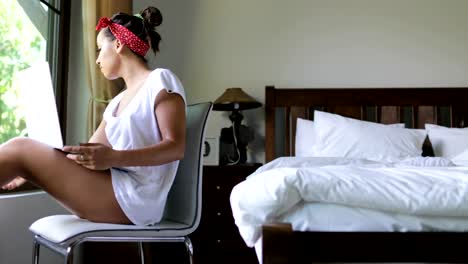 Young-Woman-Using-Laptop-Computer-Drink-Coffee-Beautiful-Girl-Chatting-Online-In-Bedroom-Morning-Over-Big-Window