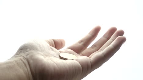 Man-hand-begging-on-a-white-background-with-coin-falling-into-hand-in-slow-motion.-Concepts-and-ideas