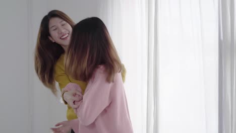 Beautiful-young-asian-women-LGBT-lesbian-happy-couple-or-Girls-Friends-dancing-to-streaming-music-having-wild-fun-in-pajamas-on-bed-in-teenage-bedroom-hanging-out-at-home.-Spending-nice-time-at-home.