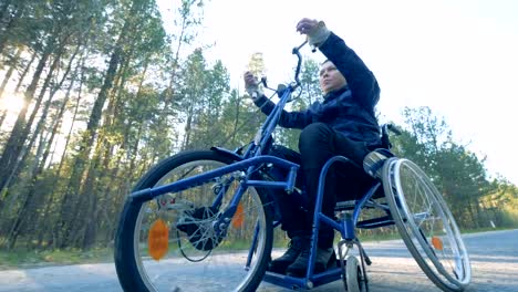 One-man-drives-on-a-medical-bicycle,-bottom-view.