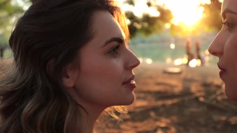 LGBT-couple-looking-at-each-other-during-sunset-golden-hour-at-park