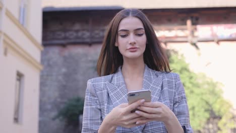 Woman-With-Phone.-Beautiful-Girl-Using-Smartphone-Outdoors