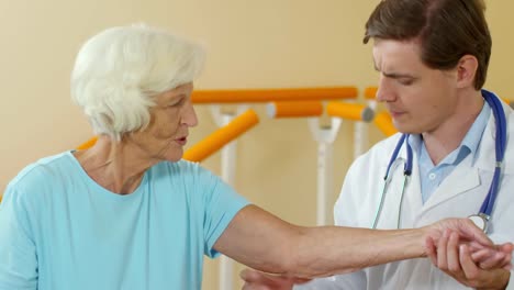 Physiotherapist-Checking-Arm-Sensitivity-of-Elderly-Patient