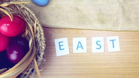 Happy-Easter-on-table-decorated-with-easter-eggs.