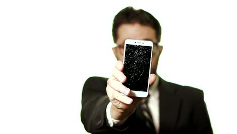 The-concept-of-a-broken-gadget.-Bearded-businessman-with-glasses-shows-a-broken-screen-smartphone,-selective-focus-moves-from-the-face-to-the-screen-of-the-smartphone.