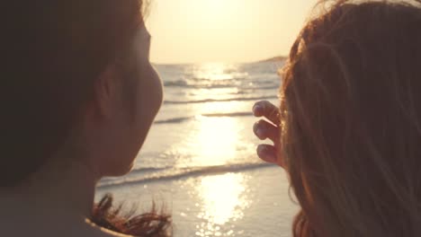 Young-Asian-lesbian-couple-kissing-near-beach.-Beautiful-women-lgbt-couple-happy-relax-enjoy-love-and-romantic-moment-when-sunset-in-evening.-Lifestyle-lesbian-couple-travel-on-beach-concept.