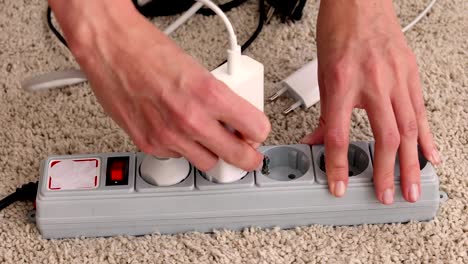 Hands-turn-on-and-plug-wires-from-electricity-switch