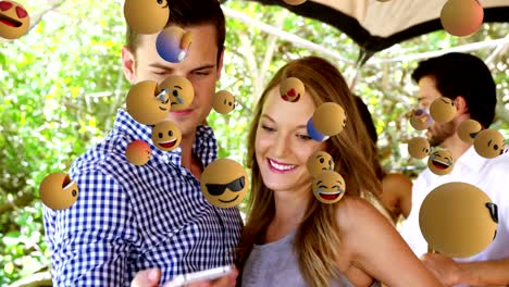 Emoji-icons-with-couple-taking-a-selfie-in-the-background-4k