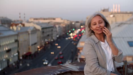 Good-looking-Elderly-Woman-Talking-on-Telephone-on-Roof