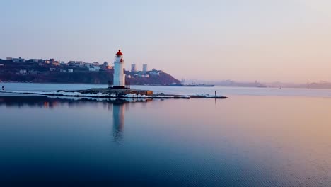 Aerial-winter-view-of-the-Tokarevskiy-lighthouse---one-of-the-oldest-lighthouses-in-the-Far-East,-still-an-important-navigational-structure-and-popular-attractions-of-Vladivostok-city,-Russia.