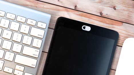 White-Camera-Privacy-Cover.-Slide-Webcam.-Cover-for-an-electronic-device-with-keyboard-and-mouse-on-a-wooden-table