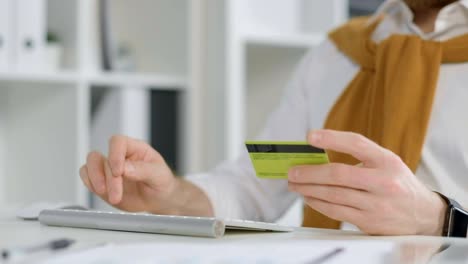 Man-entering-credit-card-information-on-keyboard