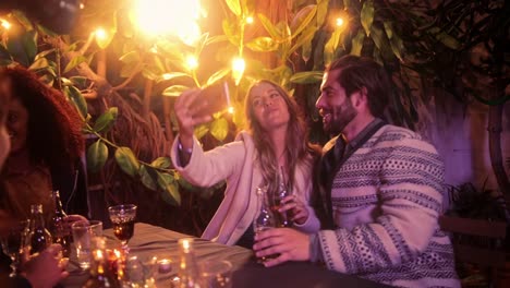 Close-up-caucasian-couple-taking-selfie-with-smartphone-on-patio