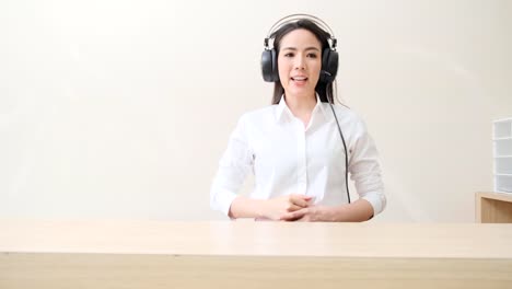 Young-attractive-Asian-female-doctor-diagnosis-talking-and-looking-to-camera-in-video-conference-,Positive-doctor-waving-and-having-online-consultation-on-digital-tablet-laptop