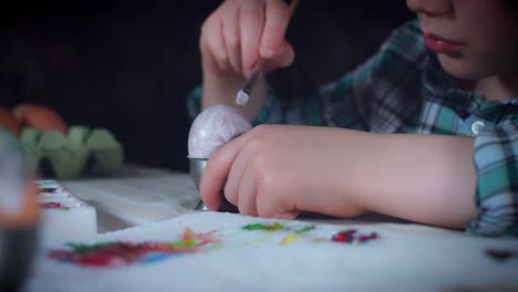 4K-Home-Shot-Of-Child-Painting-Easter-Eggs