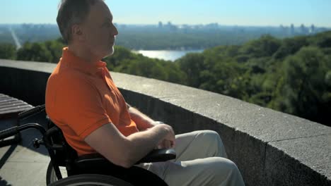 Thoughtful-wheelchaired-man-enjoying-the-city-view