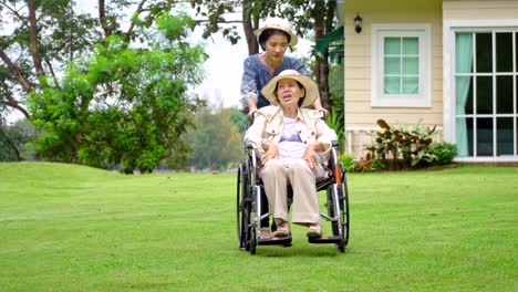 Elderly-woman-relax-on-wheelchair-in-backyard-with-daughter