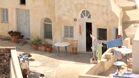 Courtyard-of-residential-household-on-summer-sunny-day,-towels-hanging-on-ropes