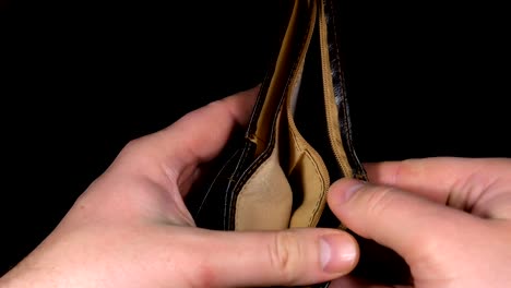 Female-hands-holding-empty-purse.-oung-woman-shows-her-empty-wallet.-Bankruptcy.